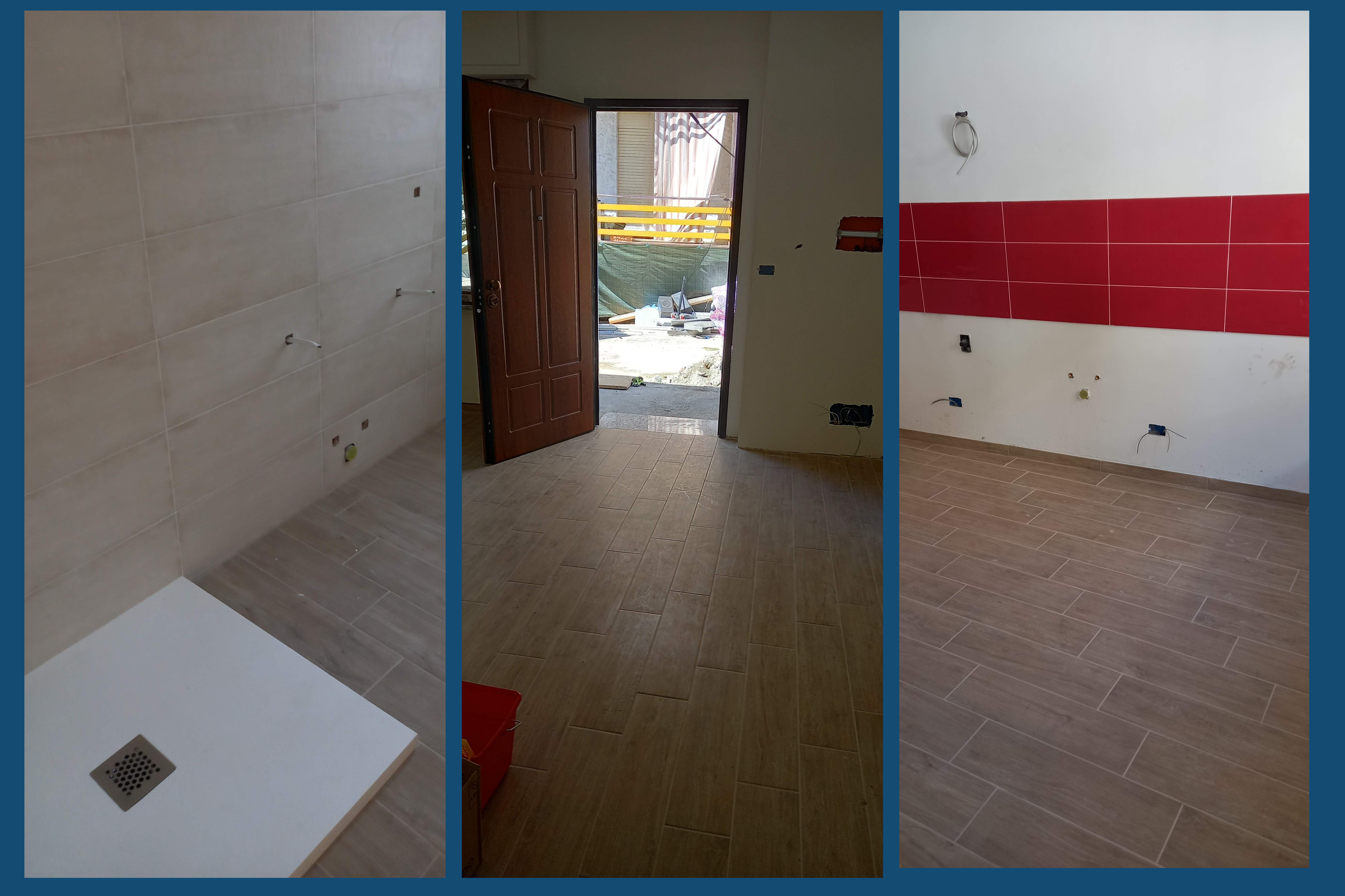 porta, piastrelle interne sui muri rosse, bagno con piatto doccia e pavimentazione